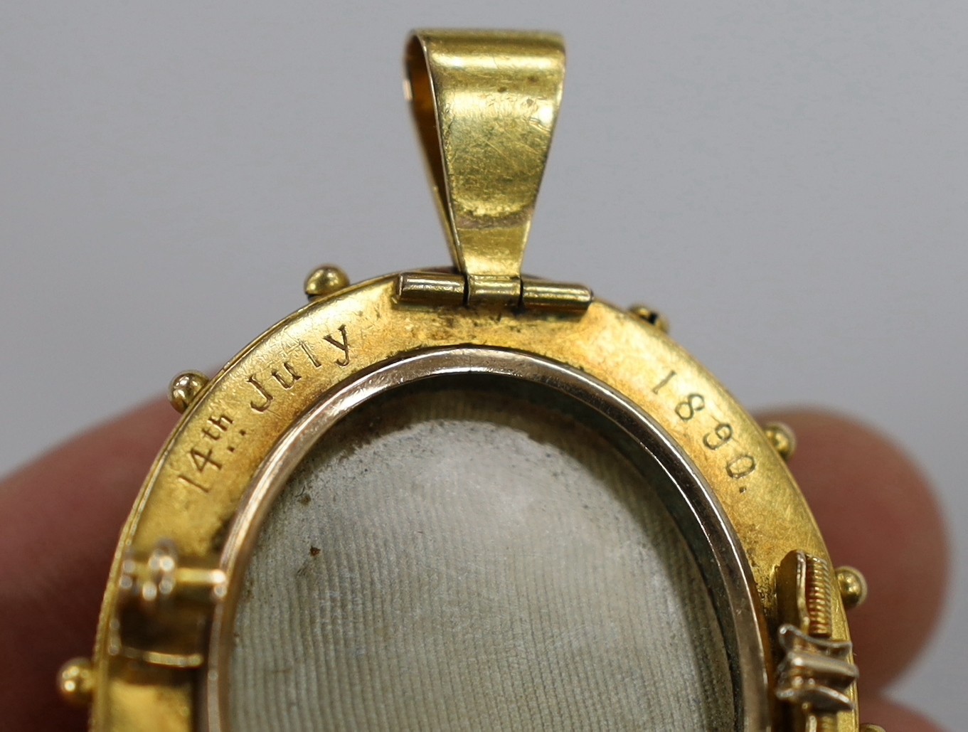 A Victorian yellow metal and hardstone cameo set oval pendant brooch (pin missing) with cannetile work decoration and engraved inscription verso, the stone carve with bust of a lady to dexter, overall 55mm, gross weight